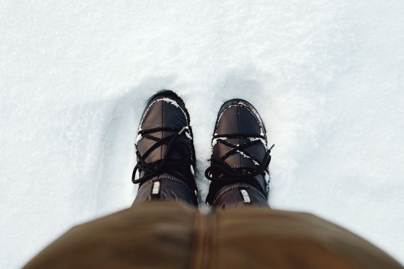 Legs in boots in snow