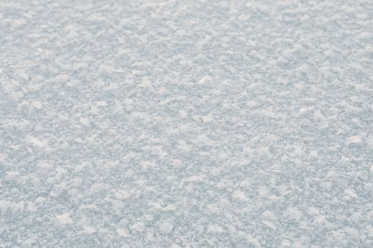 Close-up of a snowy texture on the ground, capturing the essence of winter.