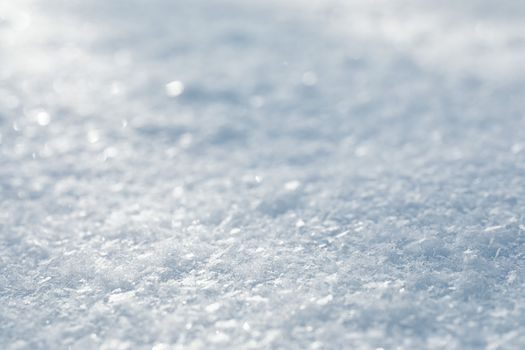 Detailed macro shot of a snow-covered surface showcasing delicate ice crystals.