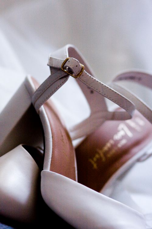 Free Detailed close-up of stylish white leather high heels with an elegant buckle strap. Stock Photo