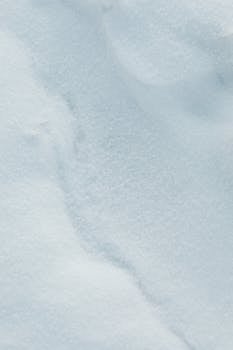Detailed close-up of fresh, white snow texture on a winter day.