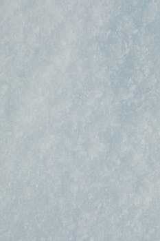 Close-up of a textured snow and ice surface, ideal for winter backgrounds.