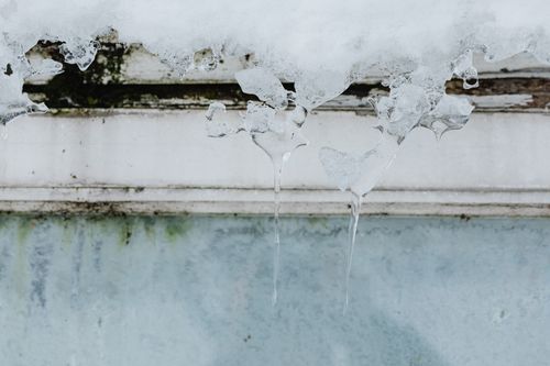 Free Detailed view of icicles hanging from a building in winter. Stock Photo