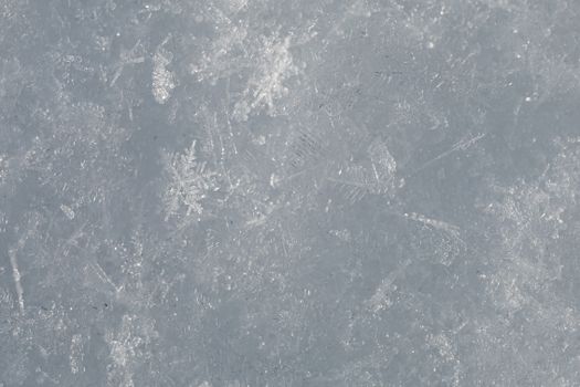 Detailed close-up of beautiful snowflakes highlighting frosty winter textures.