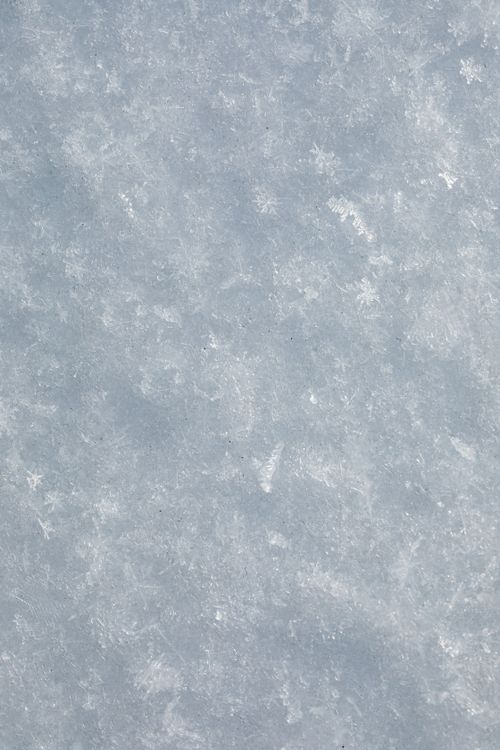 Free Close-up view of a frosty snow surface, showcasing intricate ice patterns. Stock Photo