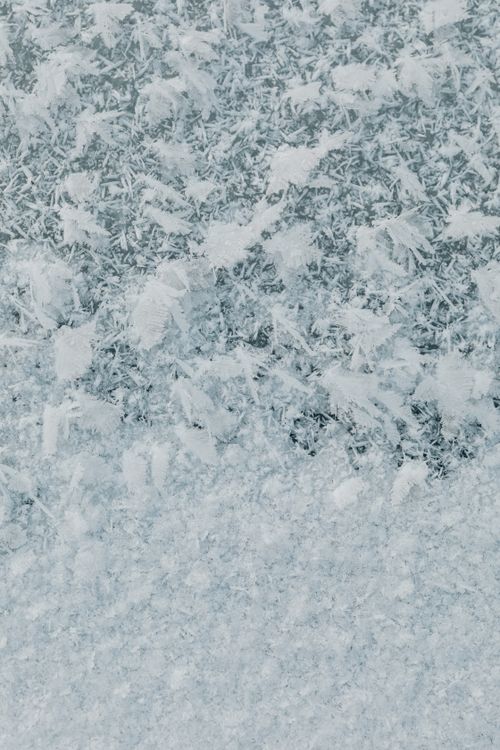 Free Detailed view of ice crystal patterns on a frosty winter window surface. Stock Photo