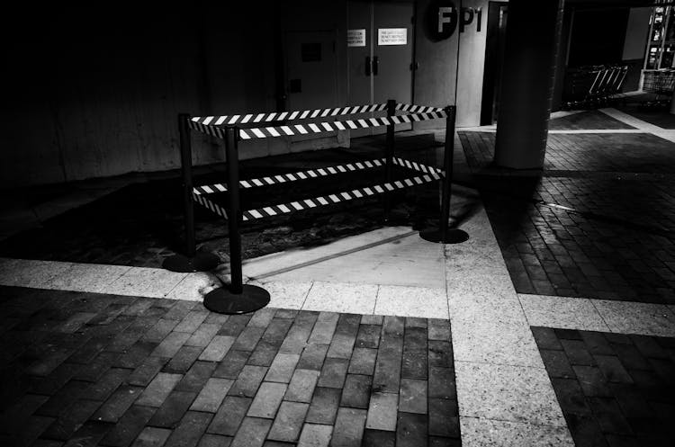 Barrier With Retractable Tape On Sidewalk