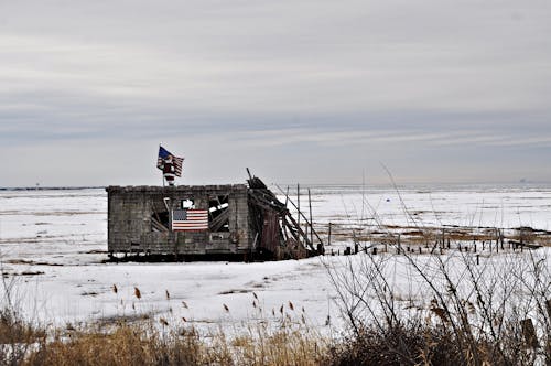 American Flags on Ruined Shed in Winter
