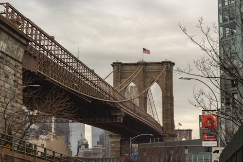 The Brooklyn Bridge with American Flag in New York, USA