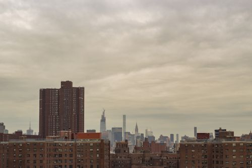 Free Dreary cityscape under a gray sky featuring modern skyscrapers and residential buildings. Stock Photo