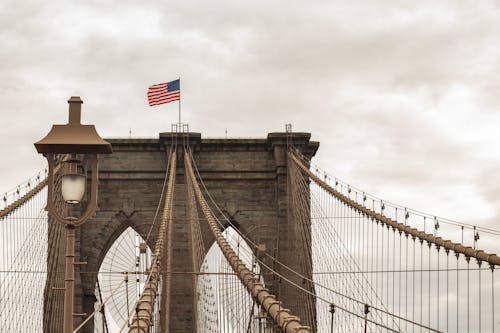 Free The American Flag on Top of the Brooklyn Bridge in New York, USA Stock Photo