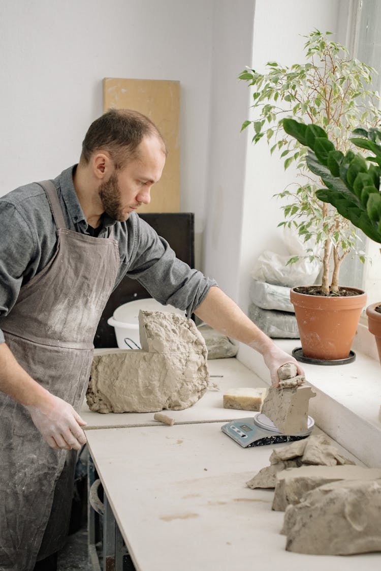 Photo Of A Potter Weighing Clay