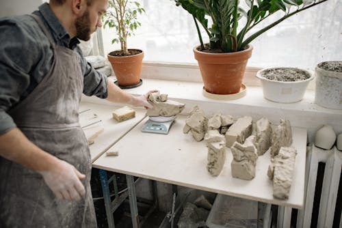 Man Weighing Clay in Workshop