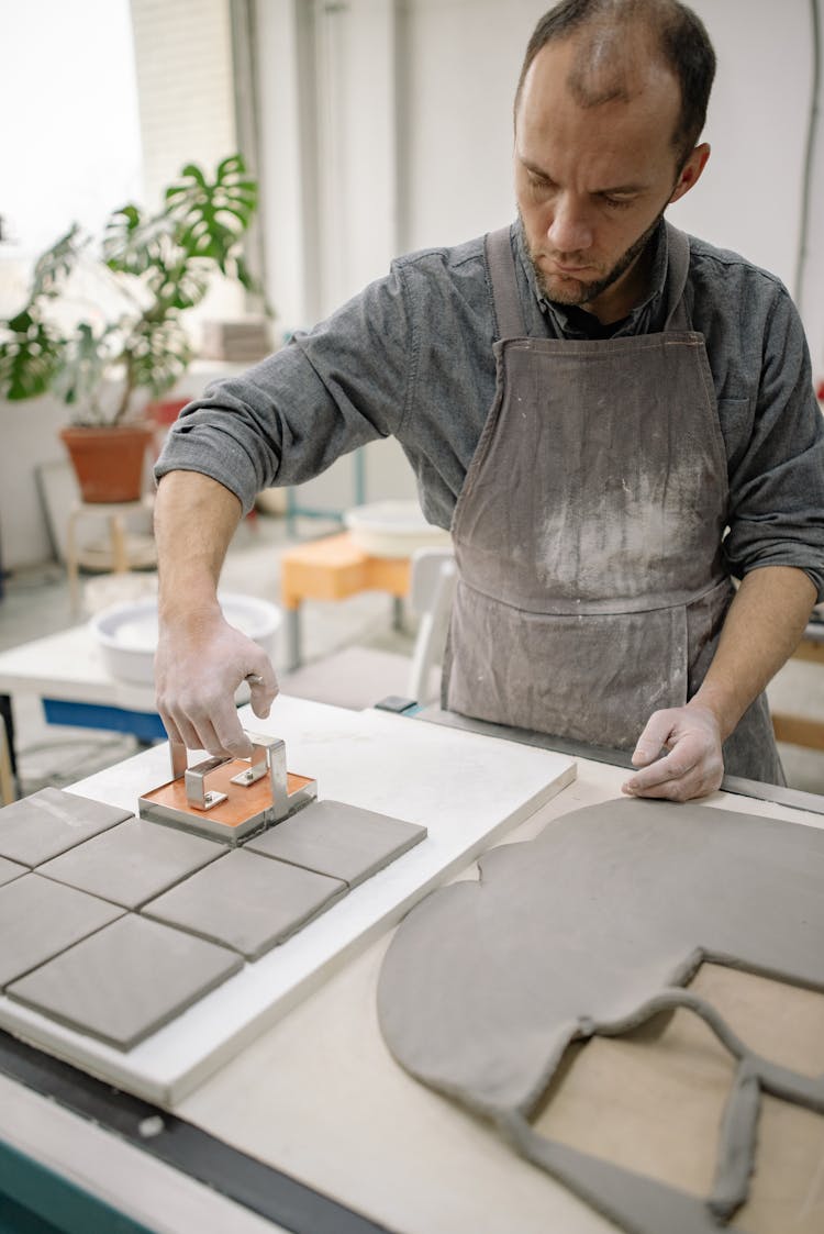 Potter Cutting Out Slabs Of Clay 