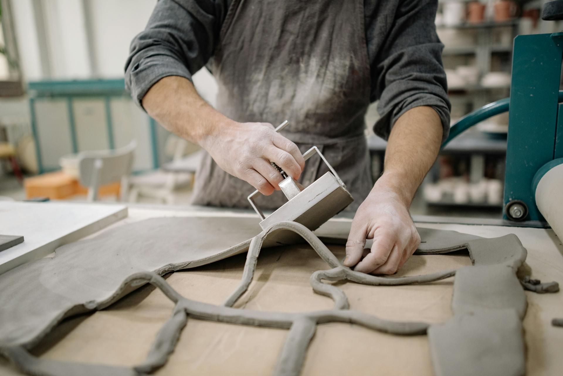 Man Cutting out Clay Tiles