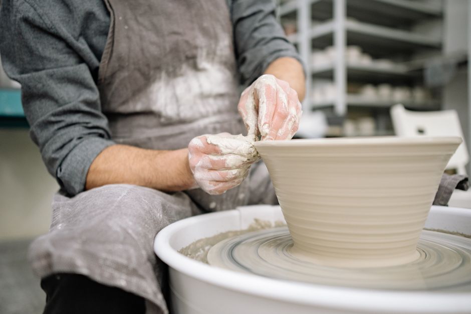 potter shaping clay wheel