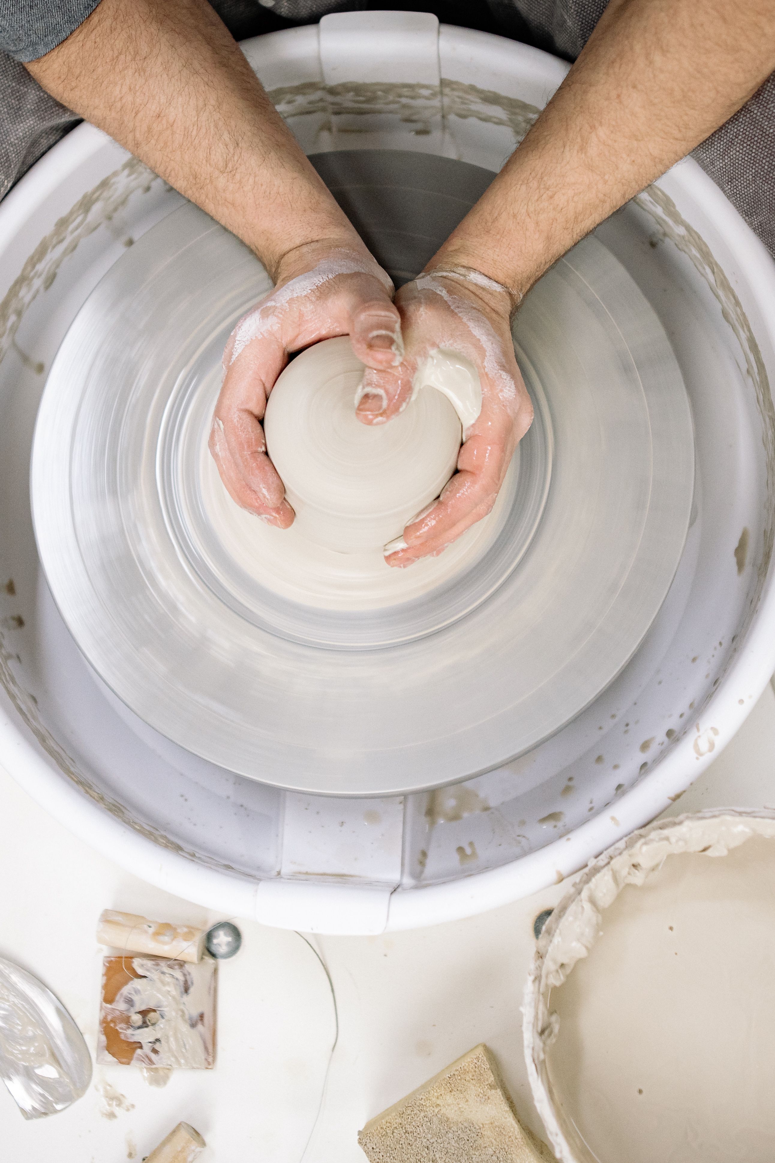 Top View of Hands Shaping Clay on a Pottery Wheel · Free Stock Photo