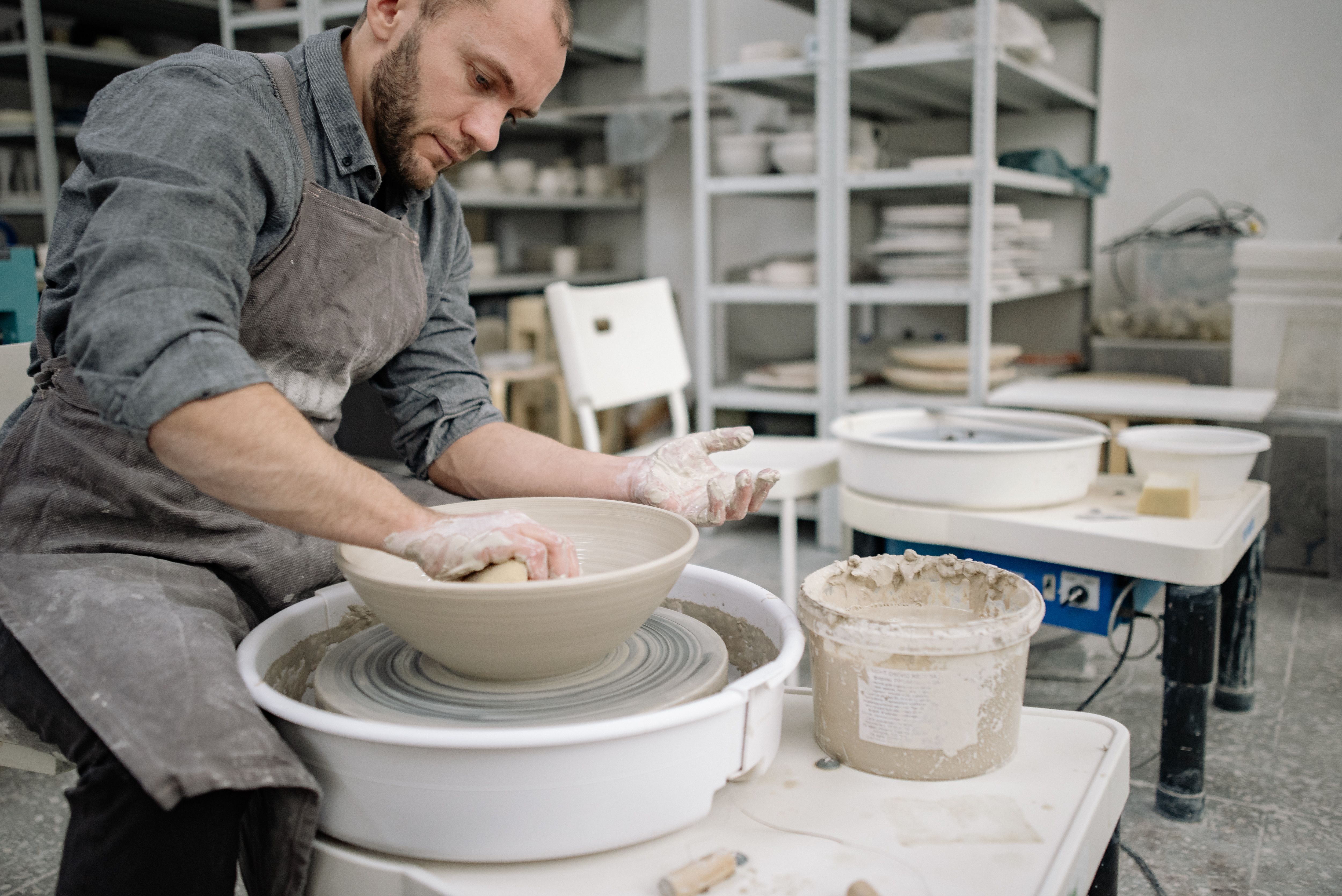 Man Making a Bowl on a Pottery Wheel · Free Stock Photo
