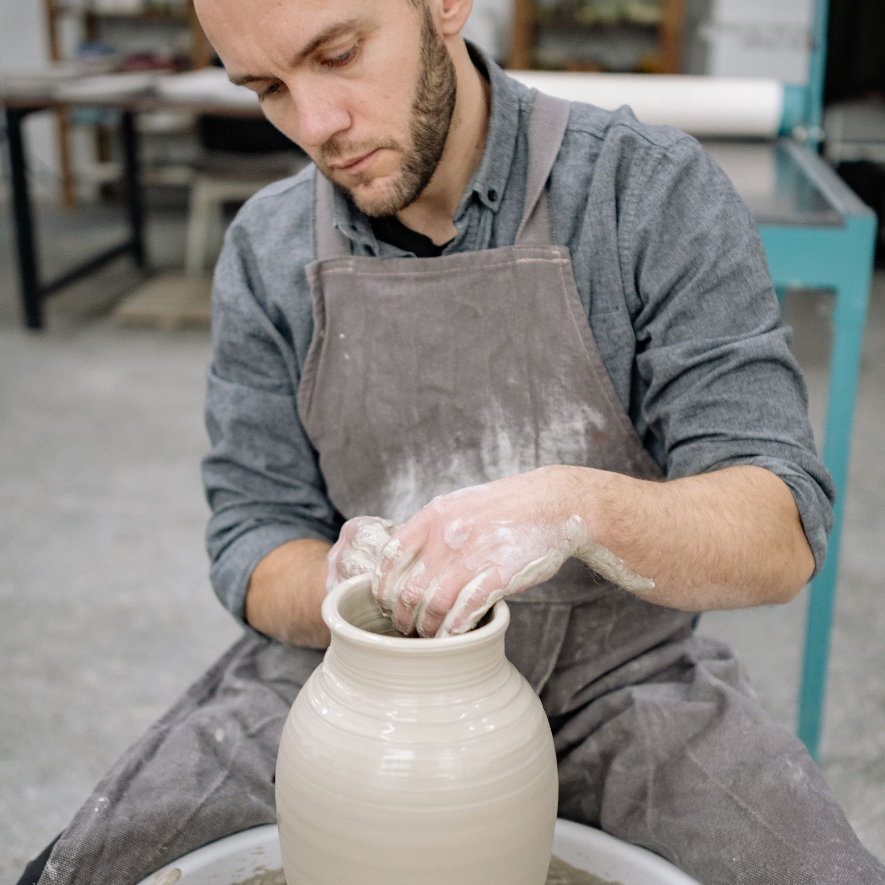 Artisan shaping pottery on a wheel