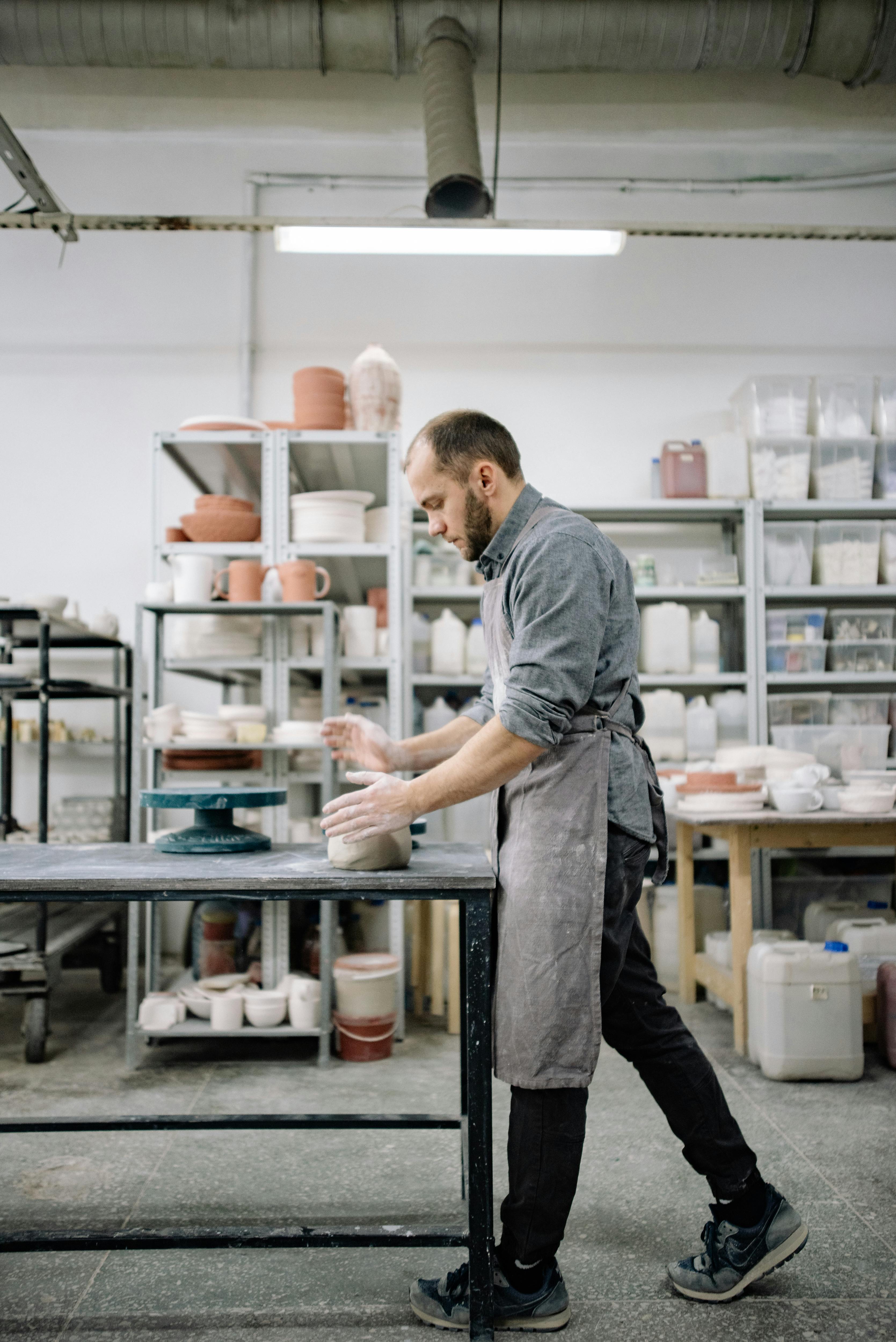 man making pottery at workshop