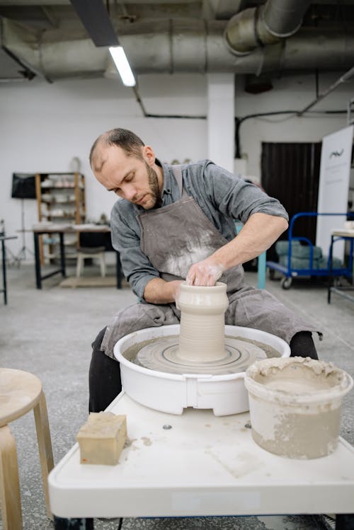 Free Potter Working at a Pottery Wheel Stock Photo