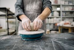 A potter shaping clay on the wheel in a studio — photo by Yan Krukau on Pexels