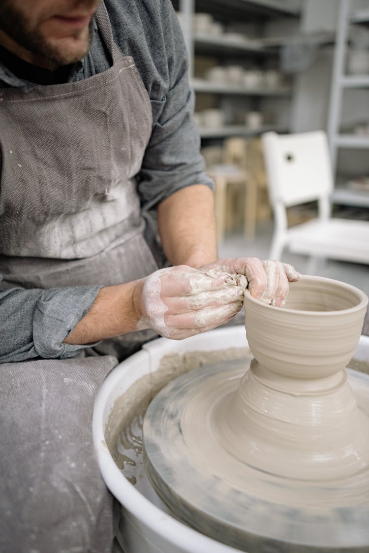 Photo Of A Man Hands Shaping Clay