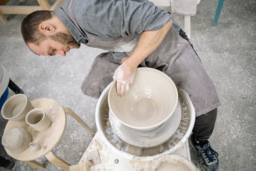 High-Angle Shot of a Man Forming a Bowl with Clay