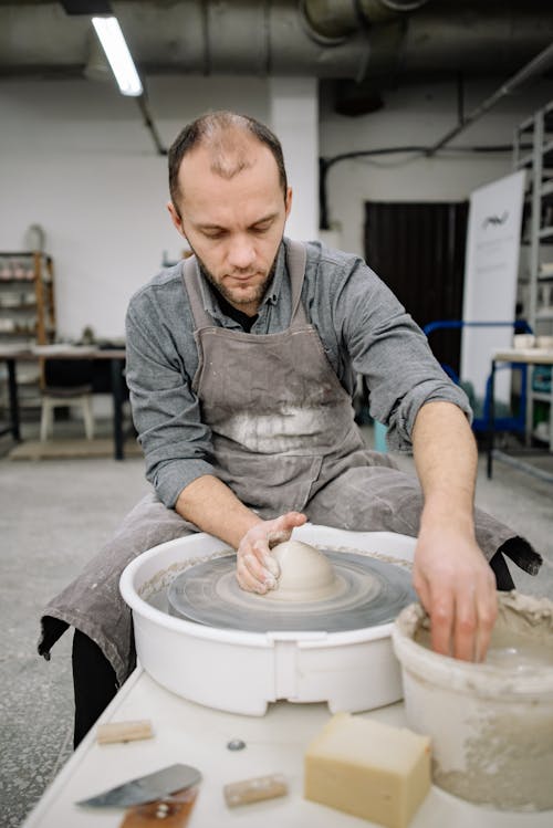 Man Working with Clay Creating Pottery