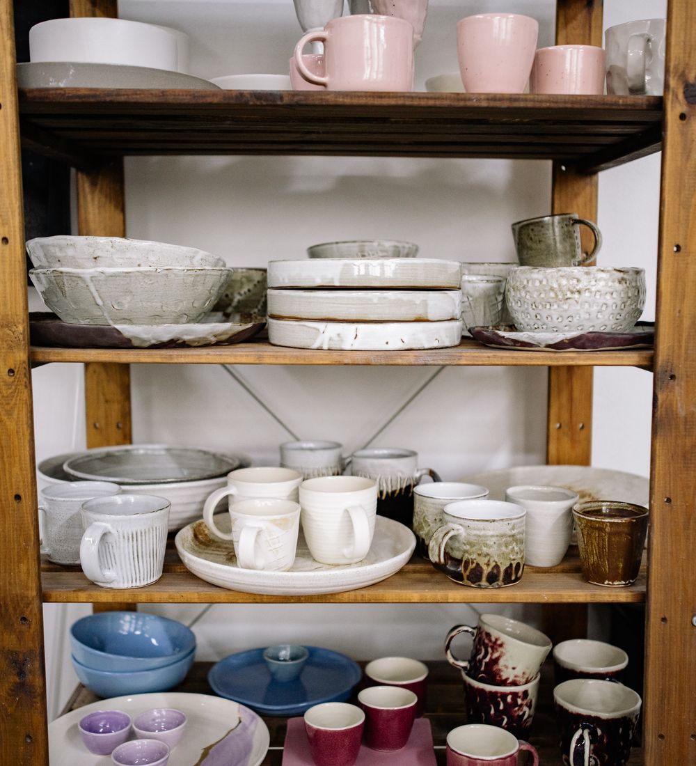 Handmade ceramic vessels on shelves