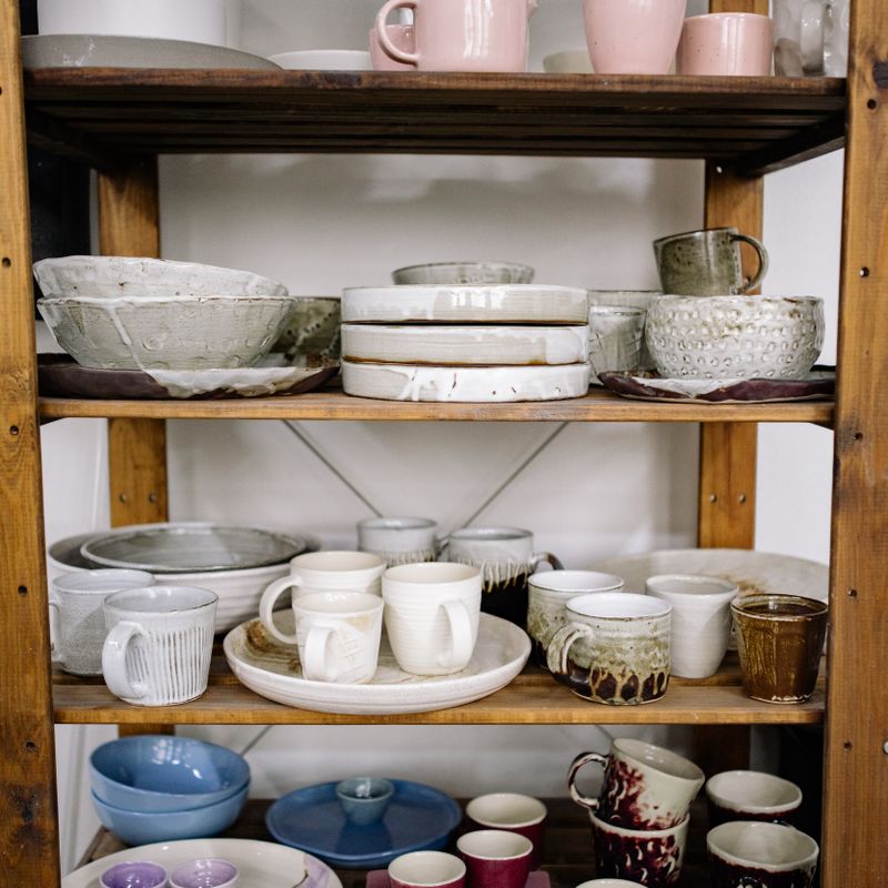 Tall handmade vessels on studio shelving