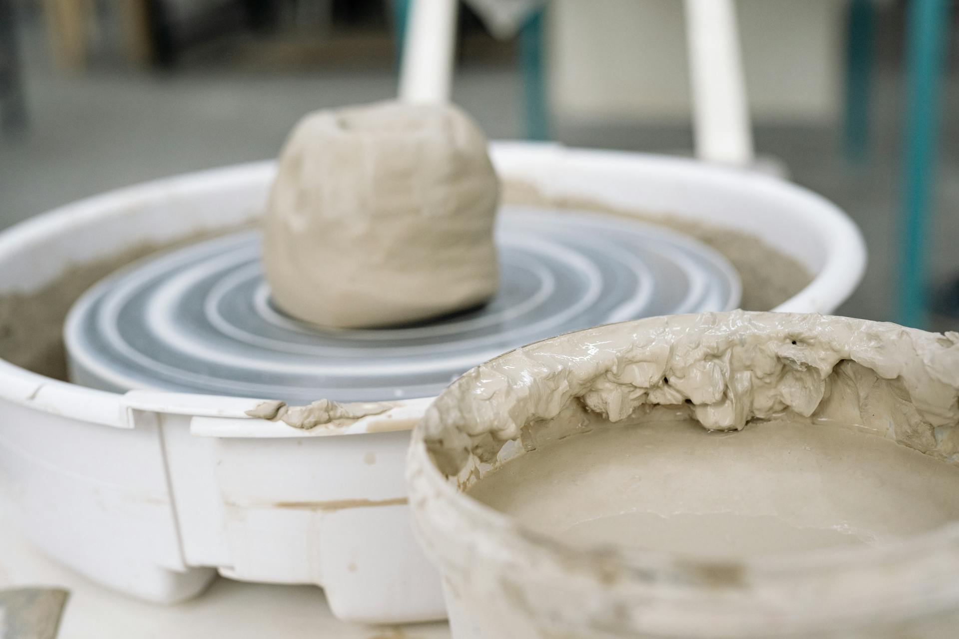 A detailed view of wet clay on a pottery wheel, highlighting the craftsmanship involved in pottery making.