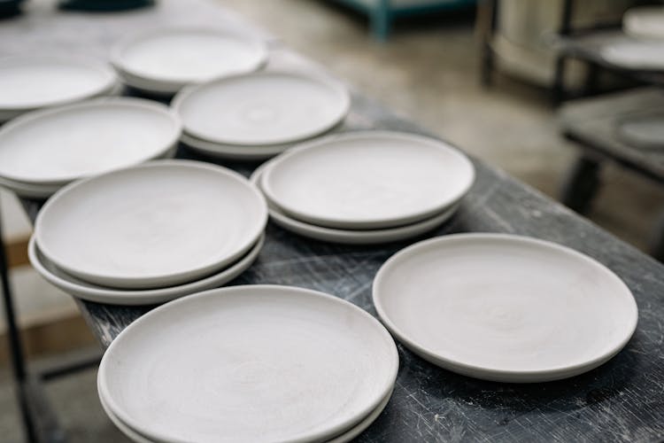 Close-Up Shot Of White Clay Plates