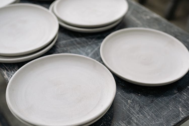 Close-Up Shot Of White Clay Plates