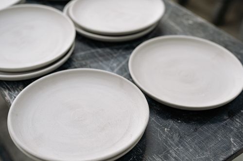 Free Artistic close-up of handcrafted ceramic plates showcasing meticulous craftsmanship. Stock Photo