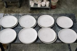 Earthenware plates on a workshop table, by Yan Krukau on Pexels