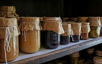 Brown Glass Jars on White Wooden Shelf