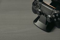 Black Game Controller on Brown Wooden Table
