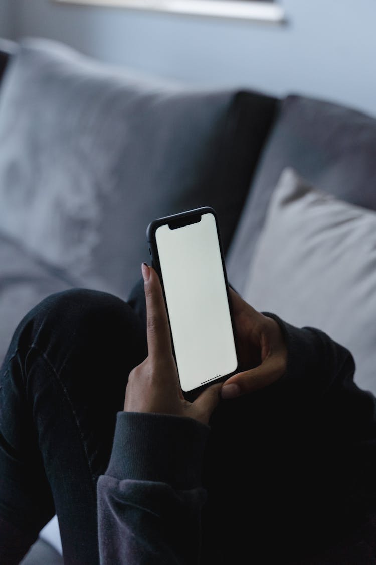 A Person Holding A Smartphone With Blank Screen