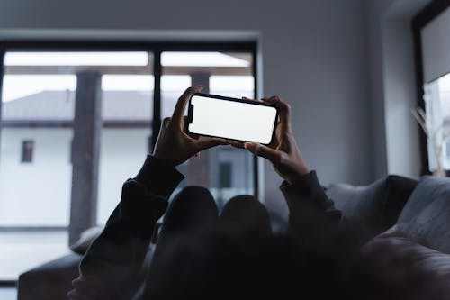 Free A Person Using a Smartphone Stock Photo