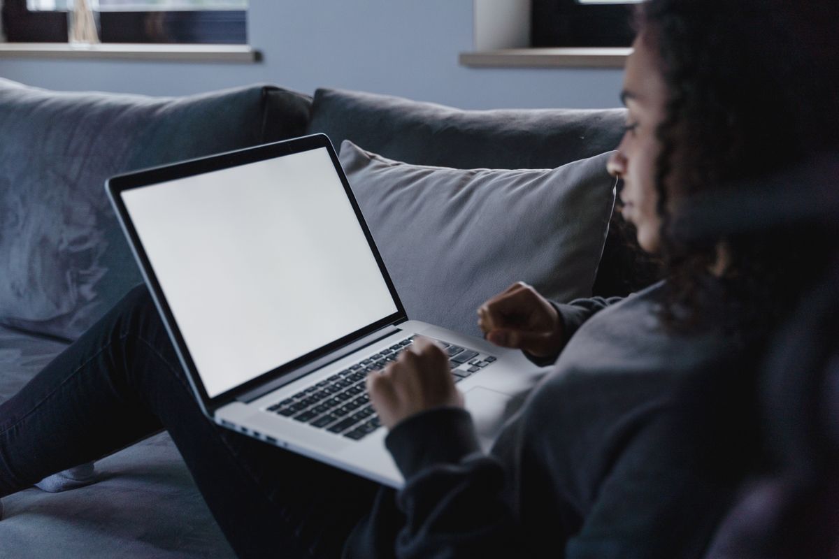 Person comparing financial options side by side on a laptop