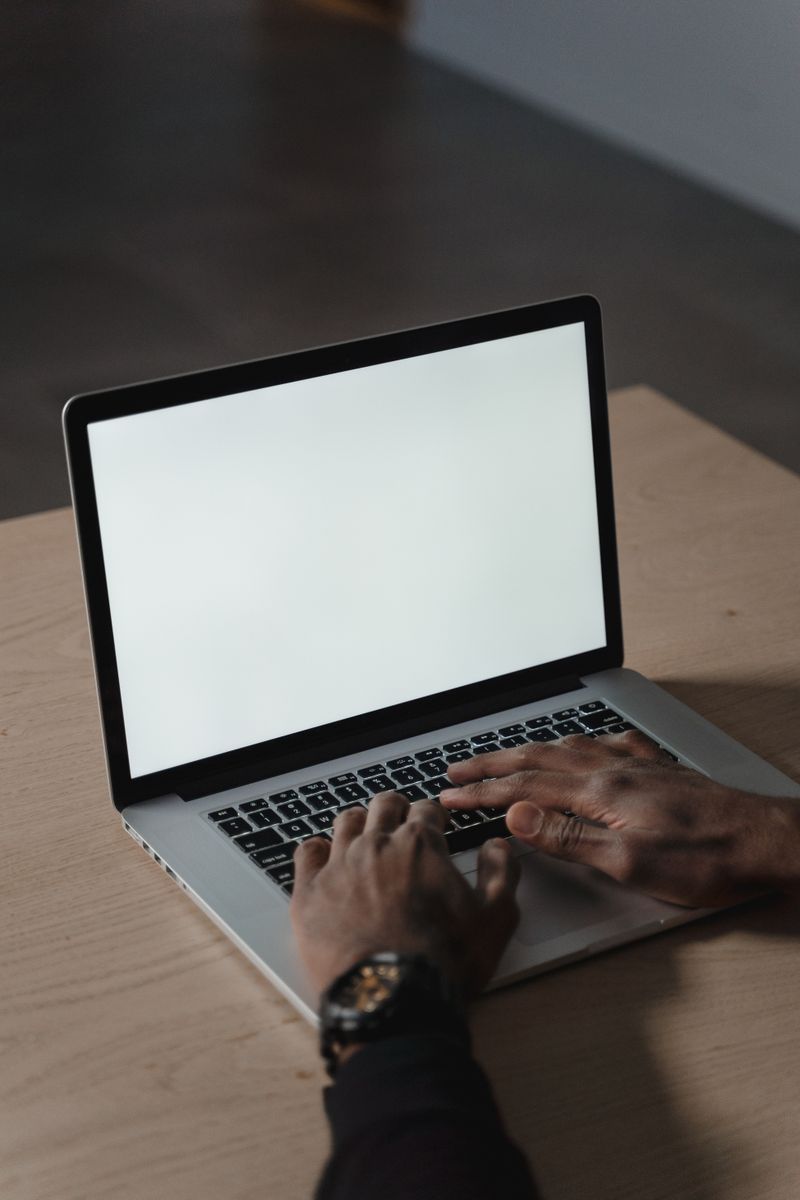 Hands typing on a laptop in a dim room — photo by Tima Miroshnichenko on Pexels