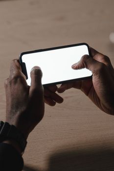 Hands holding a blank smartphone screen, ideal for mockup use. Perfect for technology themes.