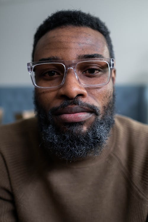 Close-Up Shot of a Bearded Man with Eyeglasses