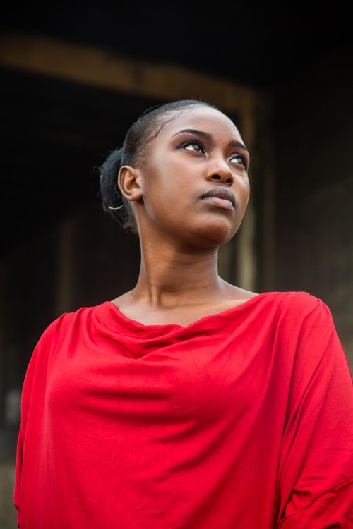Free Portrait of a woman in a red top with a confident gaze outdoors in Lusaka. Stock Photo