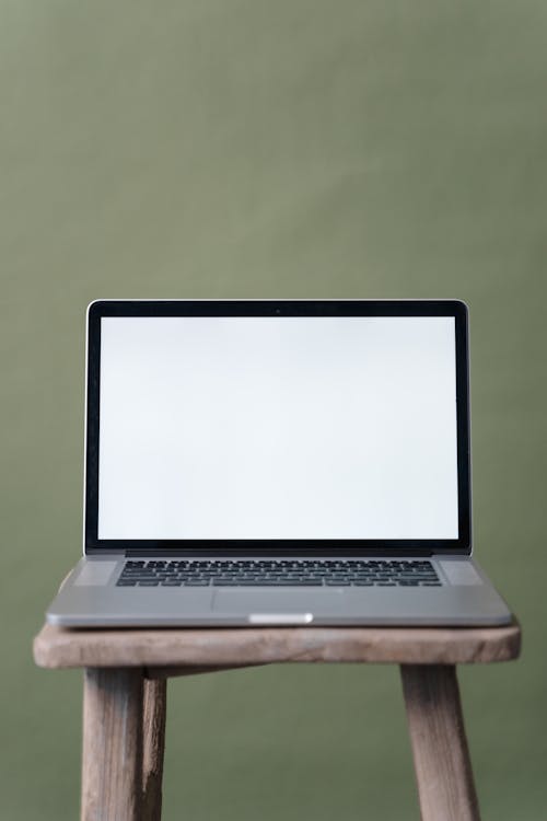 Gray and Black Laptop on Brown Wooden Table