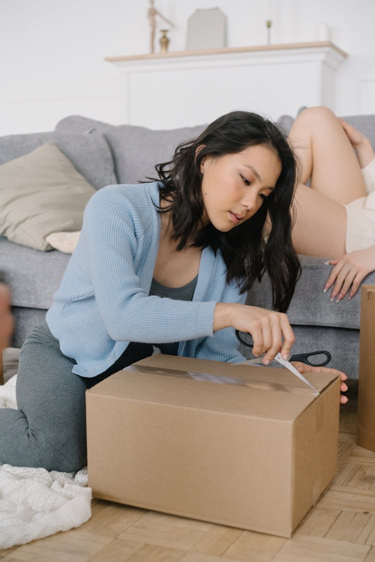 A Woman Opening A Box