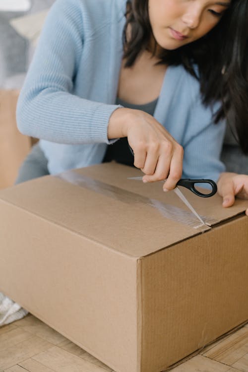 A Woman Opening a Box