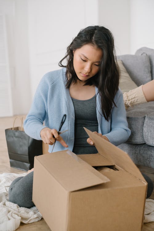 A Woman Opening a Box