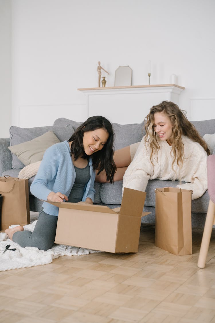 Women Busy Opening The Cardboard Box